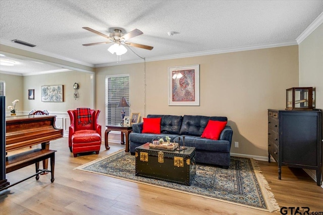 2733 Rockbridge Rd, Tyler, TX 75701 - living area featuring wood finished floors, ceiling fan, ornamental molding, and a textured ceiling