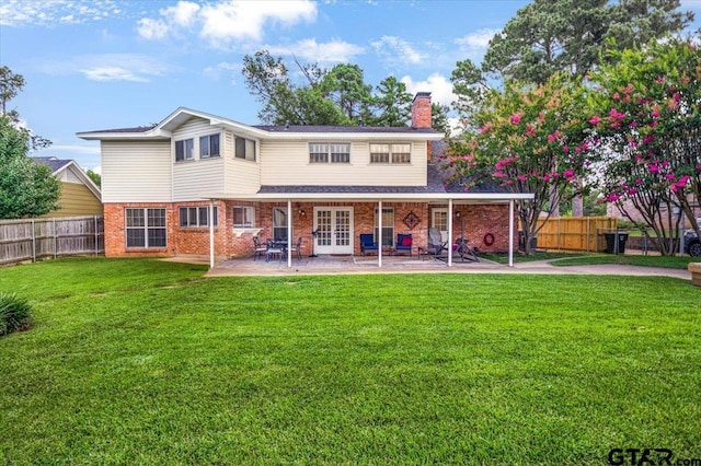 2733 Rockbridge Rd, Tyler, TX 75701 - rear view of property with a chimney, a patio, brick siding, and french doors