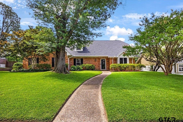 2733 Rockbridge Rd, Tyler, TX 75701 - view of front of home with brick siding, a front yard, and roof with shingles