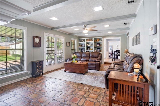 2733 Rockbridge Rd, Tyler, TX 75701 - living room with crown molding, a textured ceiling, ceiling fan, french doors, and built in shelves