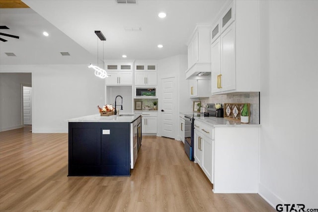2099 Jackie Ave, Tyler, TX 75703 - kitchen featuring electric stove, light wood-type flooring, decorative backsplash, white cabinetry, and recessed lighting