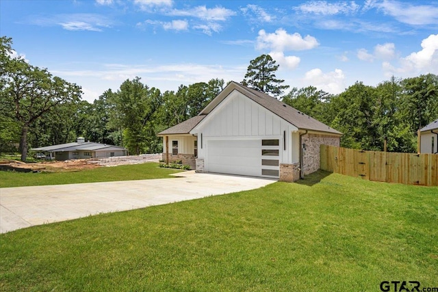 2099 Jackie Ave, Tyler, TX 75703 - view of front facade with board and batten siding, an attached garage, concrete driveway, and a gate