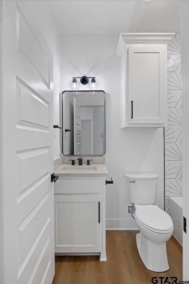 2099 Jackie Ave, Tyler, TX 75703 - full bathroom featuring vanity, wood finished floors, and a bathtub