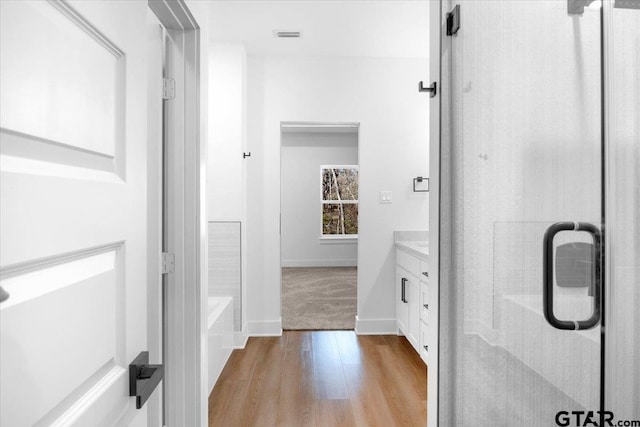 2099 Jackie Ave, Tyler, TX 75703 - bathroom with a stall shower, vanity, wood finished floors, and a tub