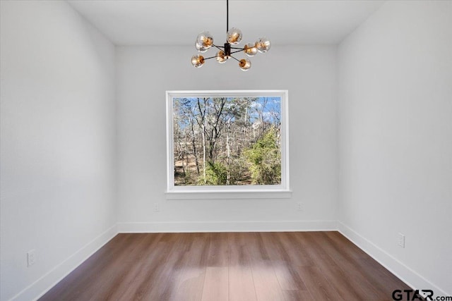 2099 Jackie Ave, Tyler, TX 75703 - unfurnished dining area featuring a chandelier and dark wood-style floors