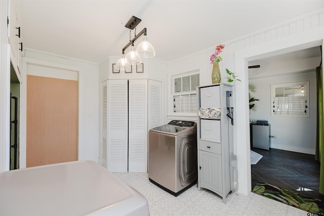 kitchen featuring pendant lighting, washer / clothes dryer, and ornamental molding