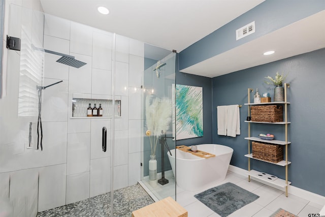 full bathroom with baseboards, visible vents, a freestanding tub, a stall shower, and tile patterned flooring