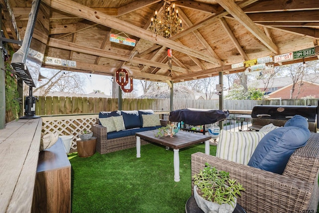 view of patio with a gazebo, an outdoor living space, and a fenced backyard