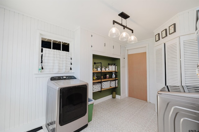 washroom featuring light floors and washer and clothes dryer