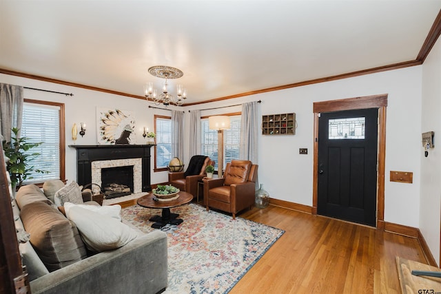 living room with plenty of natural light, wood finished floors, baseboards, and ornamental molding