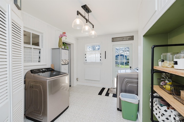 laundry room with washer and dryer, crown molding, tile patterned floors, and laundry area