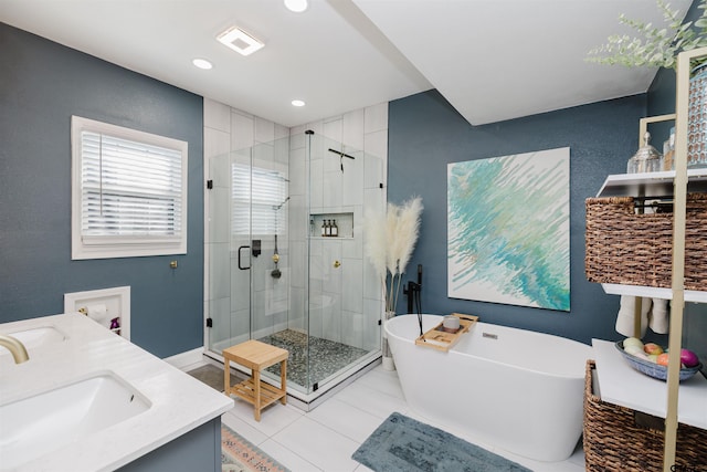 bathroom featuring a freestanding tub, visible vents, a sink, a shower stall, and double vanity