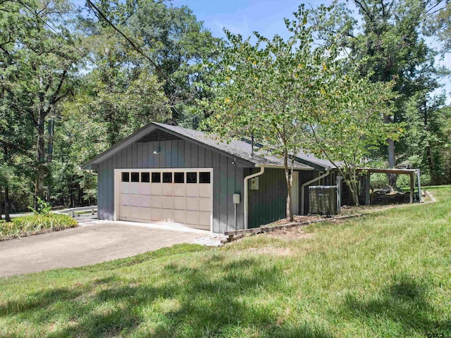 view of side of property featuring a garage and a yard