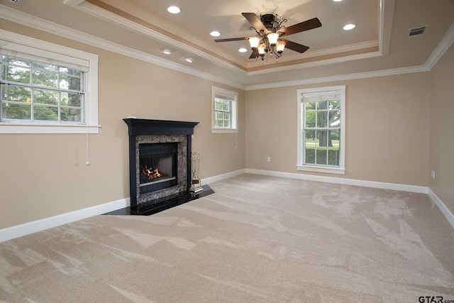 18722 Ridgeline Rd, Tyler, TX 75703 - unfurnished living room with a tray ceiling, light colored carpet, ceiling fan, a high end fireplace, and baseboards