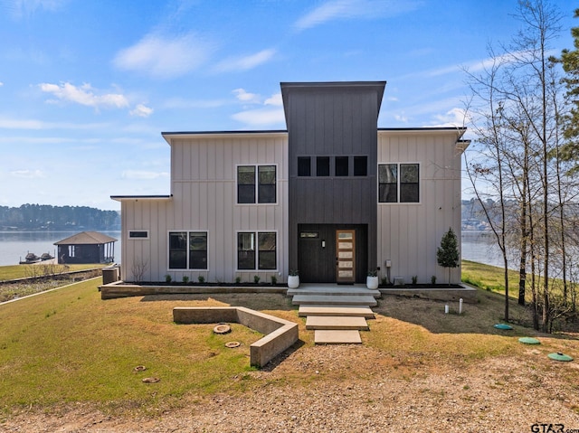 331 W Eagle Pt, Mount Vernon, TX 75457 - view of front of house with a water view, a front lawn, and board and batten siding