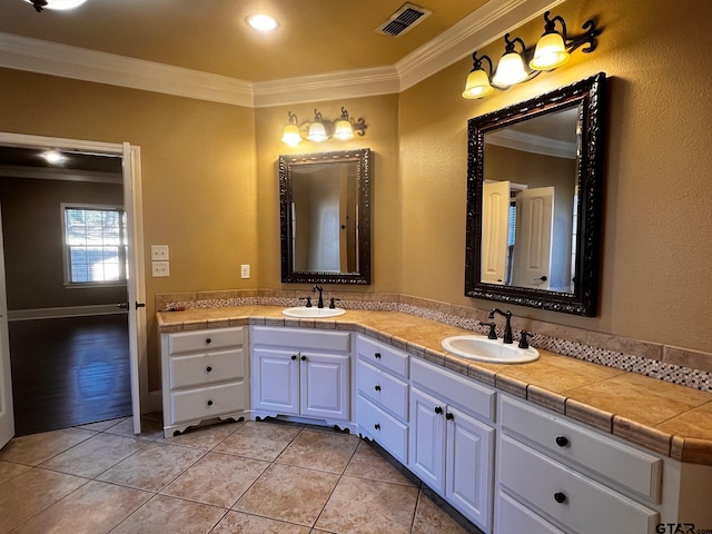 bathroom with hardwood / wood-style floors, vanity, and crown molding