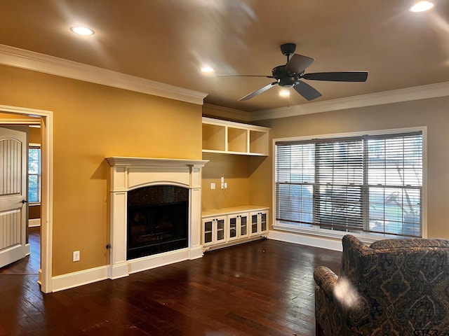 living room featuring dark wood-type flooring, ceiling fan, and crown molding