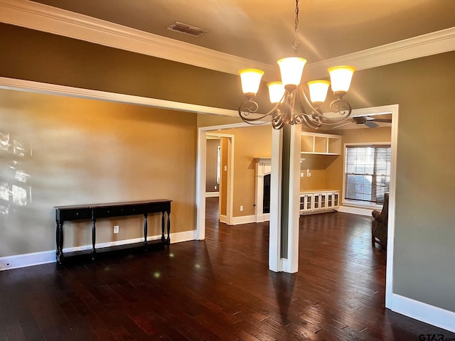 unfurnished dining area with dark hardwood / wood-style flooring, ceiling fan with notable chandelier, and crown molding