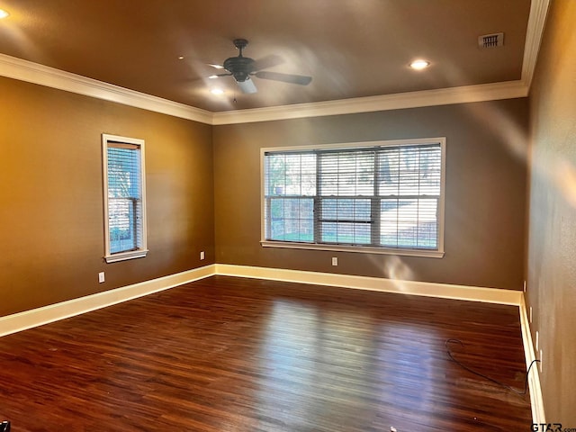 empty room with ornamental molding and dark hardwood / wood-style flooring