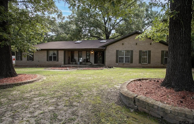 10187 Crestview Dr, Tyler, TX 75707 - back of house featuring brick siding and a lawn