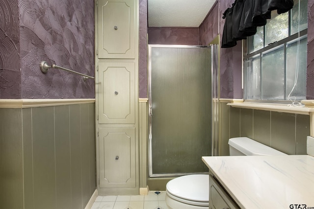 10187 Crestview Dr, Tyler, TX 75707 - bathroom with a stall shower, wainscoting, vanity, and tile patterned flooring