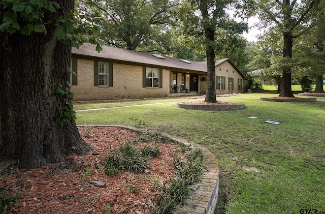 10187 Crestview Dr, Tyler, TX 75707 - view of front of home featuring a front lawn and brick siding