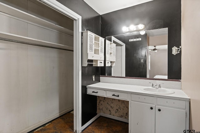 bathroom featuring baseboards, ceiling fan, visible vents, and vanity