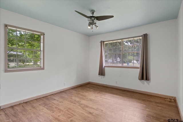 unfurnished room featuring baseboards, a healthy amount of sunlight, and light wood-style flooring