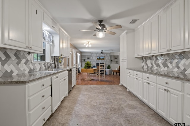 kitchen featuring white cabinets, a ceiling fan, and visible vents