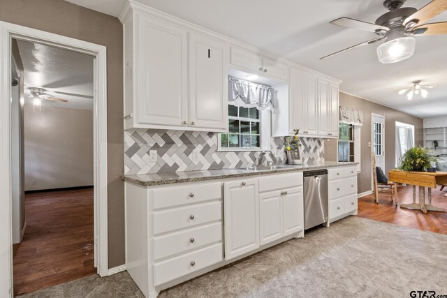 kitchen featuring a sink, ceiling fan, stainless steel dishwasher, and backsplash
