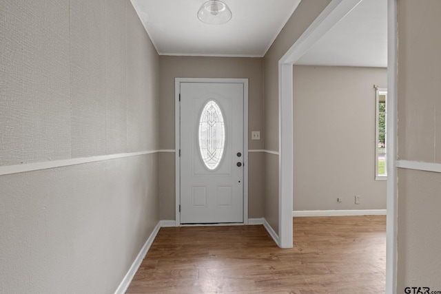 entryway featuring baseboards and wood finished floors
