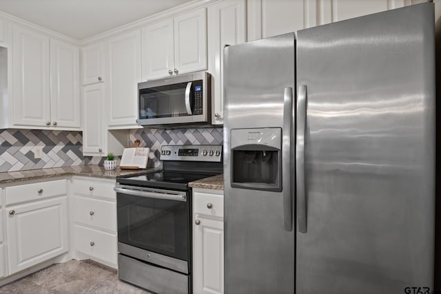 2005 Happy St, Mount Pleasant, TX 75455 - kitchen featuring stainless steel appliances, backsplash, and white cabinets