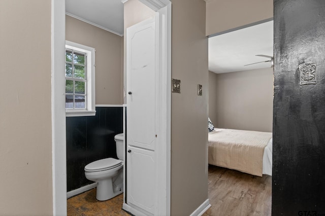 bathroom featuring crown molding, ceiling fan, and toilet