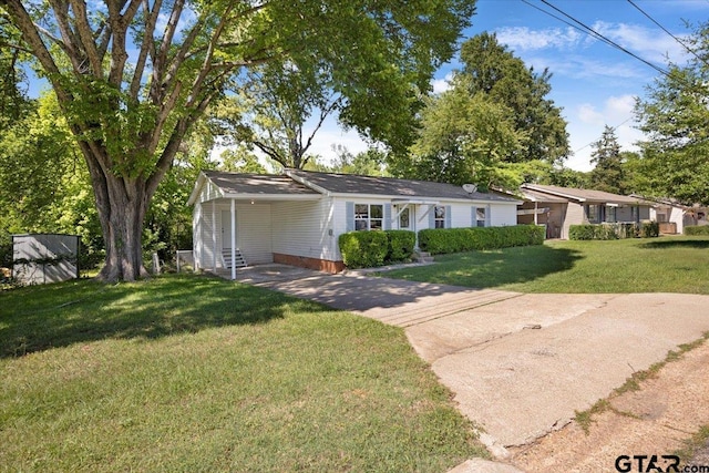 single story home featuring driveway, a front lawn, and an attached carport