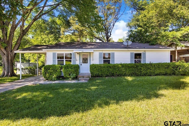 ranch-style home featuring a carport, driveway, and a front yard