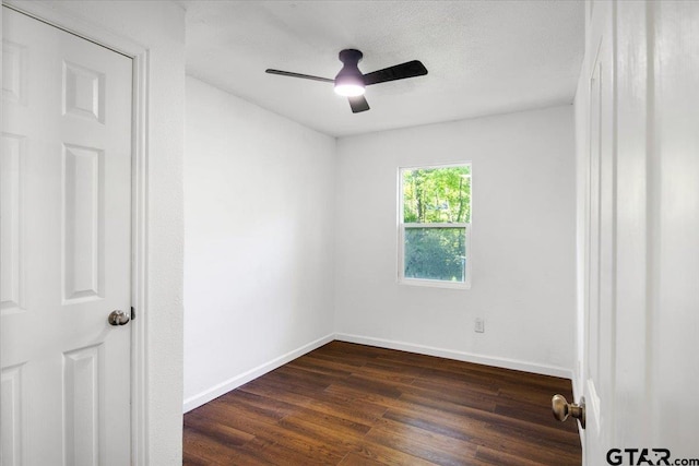 unfurnished room featuring dark wood-type flooring, baseboards, and ceiling fan