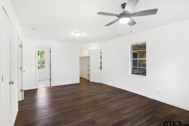 unfurnished room featuring visible vents, baseboards, a ceiling fan, and wood finished floors