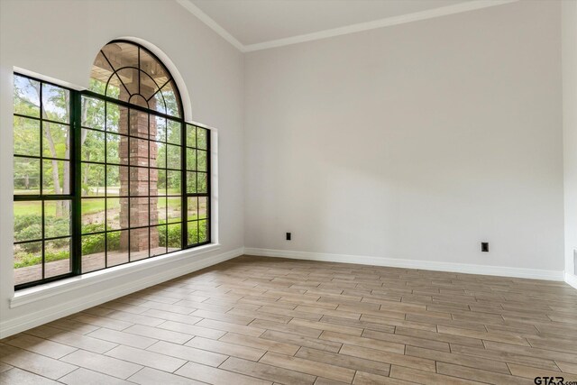 4601 Dickens, Athens, TX 75751 - empty room featuring baseboards, crown molding, plenty of natural light, and light wood-style floors