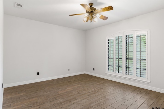 empty room with dark wood-type flooring and ceiling fan