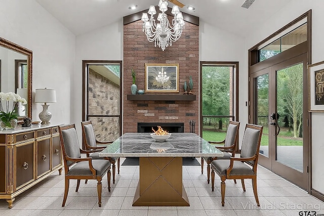 4601 Dickens, Athens, TX 75751 - dining area with a chandelier, a brick fireplace, light tile patterned flooring, and high vaulted ceiling
