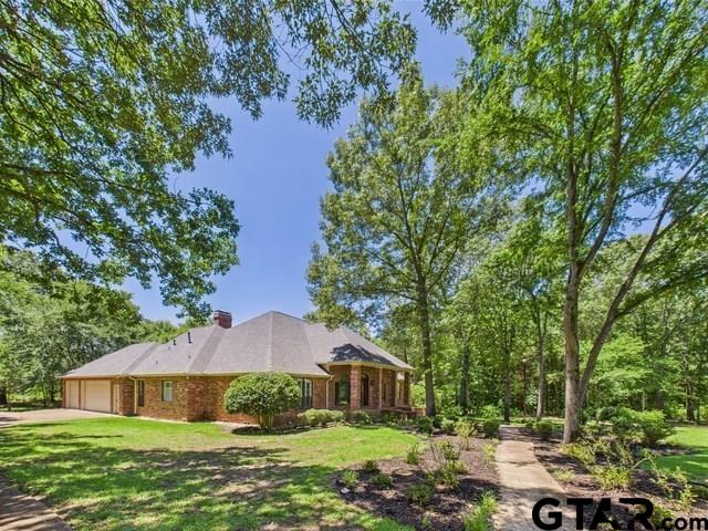 4601 Dickens, Athens, TX 75751 - view of front of house with an attached garage, a front lawn, driveway, and a chimney