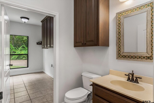 4601 Dickens, Athens, TX 75751 - bathroom featuring toilet, vanity, baseboards, and tile patterned flooring
