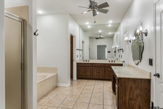 4601 Dickens, Athens, TX 75751 - bathroom featuring a ceiling fan, a bath, a stall shower, double vanity, and recessed lighting