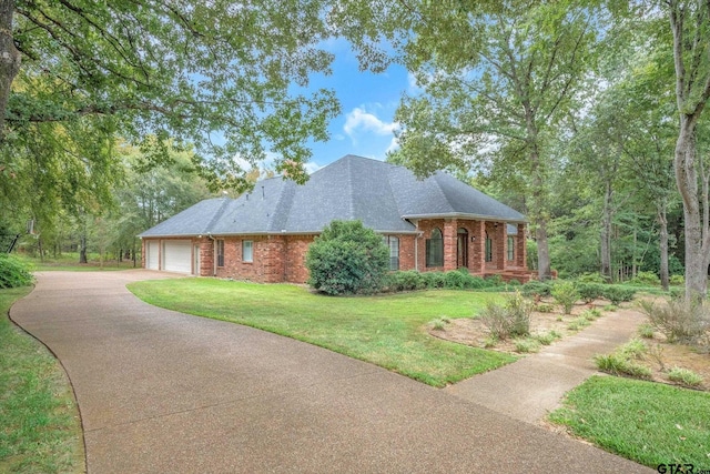 view of front of house with a garage and a front yard