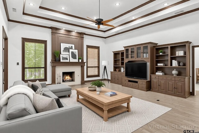 4601 Dickens, Athens, TX 75751 - living area with ceiling fan, a large fireplace, a tray ceiling, recessed lighting, and light wood-style floors