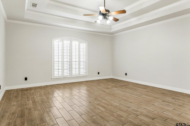4601 Dickens, Athens, TX 75751 - empty room featuring a tray ceiling, a ceiling fan, wood finished floors, baseboards, and ornamental molding