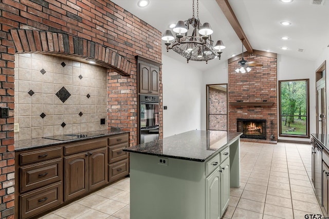 4601 Dickens, Athens, TX 75751 - kitchen with black appliances, light tile patterned floors, a ceiling fan, a chandelier, and a fireplace