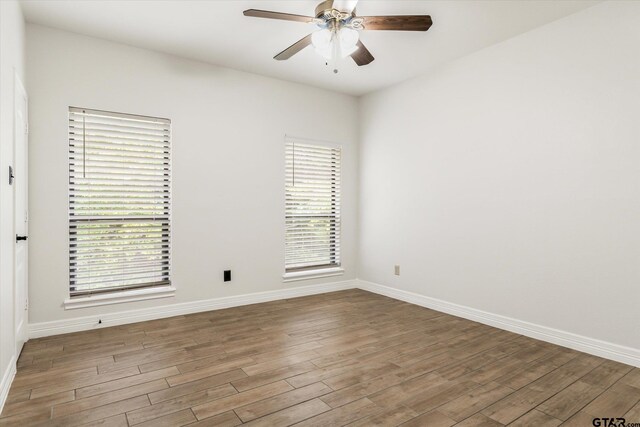 unfurnished room featuring hardwood / wood-style flooring and ceiling fan