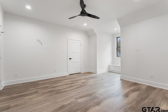 bonus room with hardwood / wood-style floors and ceiling fan