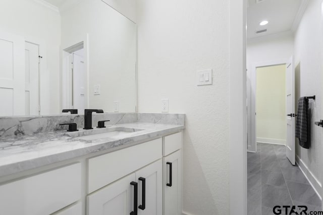 bathroom featuring vanity and crown molding